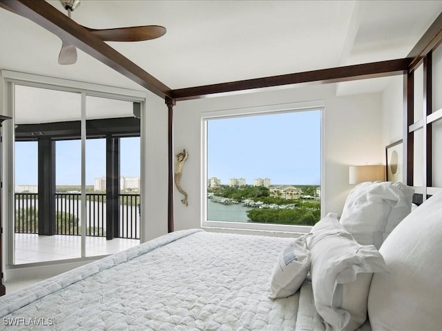 bedroom with access to exterior, multiple windows, ceiling fan, and a water view