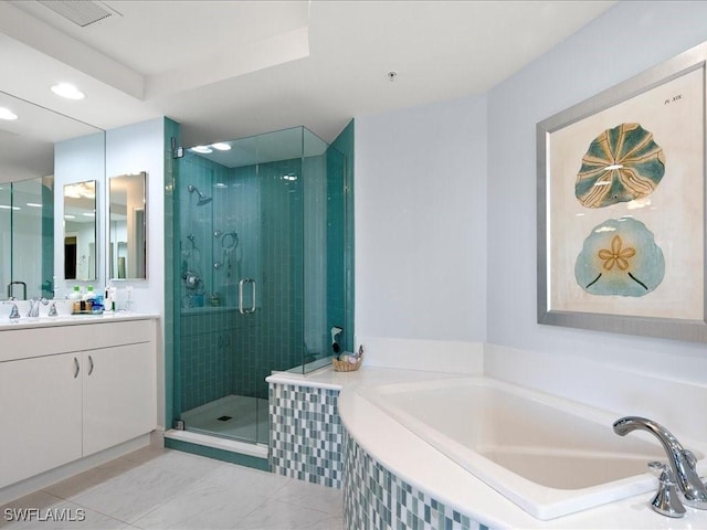 bathroom featuring shower with separate bathtub, vanity, and tile patterned flooring