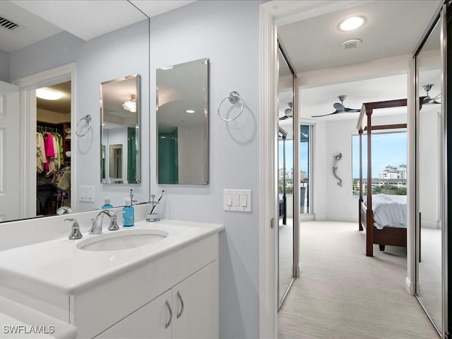 bathroom with ceiling fan and vanity