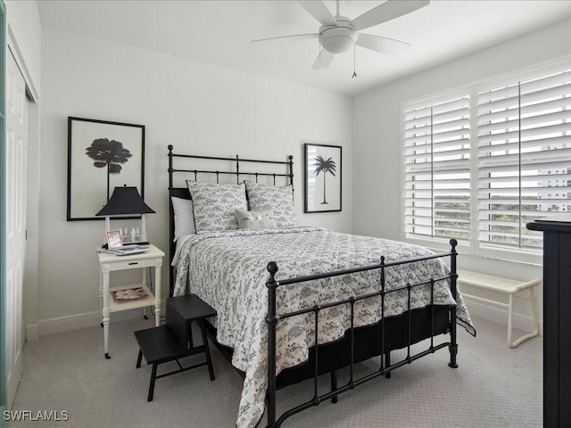 carpeted bedroom with ceiling fan and multiple windows