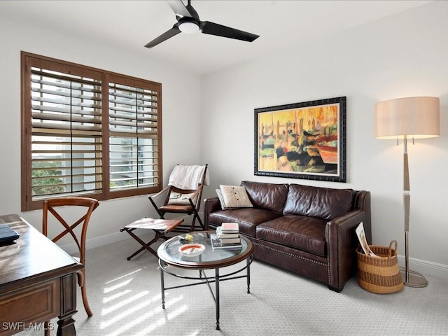 carpeted living room with ceiling fan