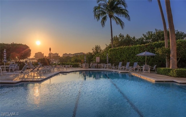 pool at dusk with a patio