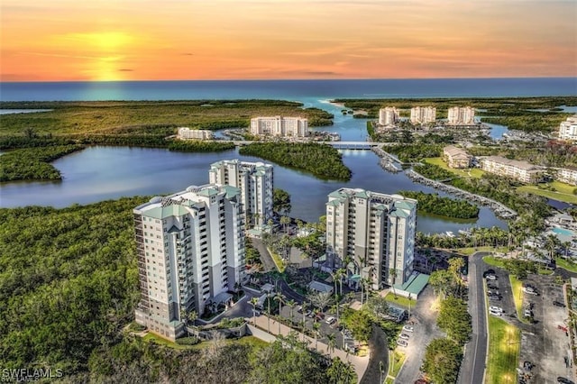 aerial view at dusk with a water view