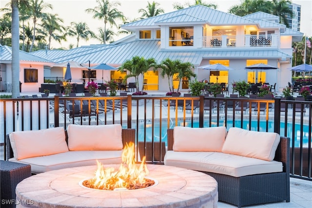 exterior space featuring an outdoor living space with a fire pit and a patio