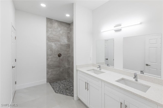 bathroom with vanity and tiled shower