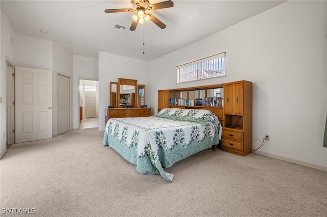 bedroom featuring ceiling fan, a closet, and light carpet