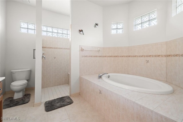 bathroom with toilet, tile patterned floors, and separate shower and tub