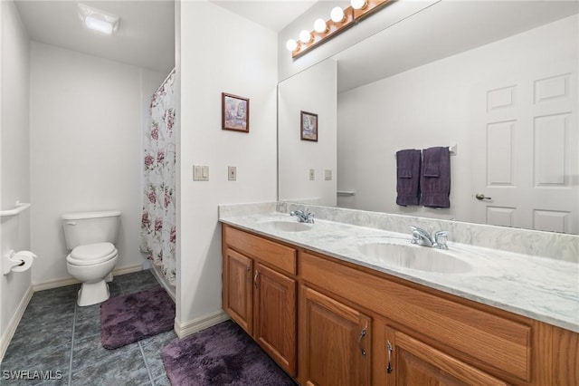 bathroom featuring toilet and vanity