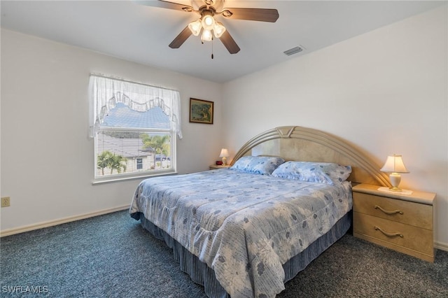 bedroom featuring ceiling fan and dark carpet