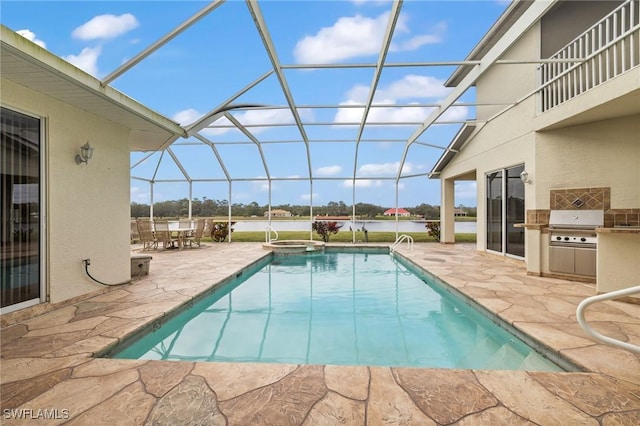 view of pool with exterior kitchen, a patio area, a lanai, and grilling area