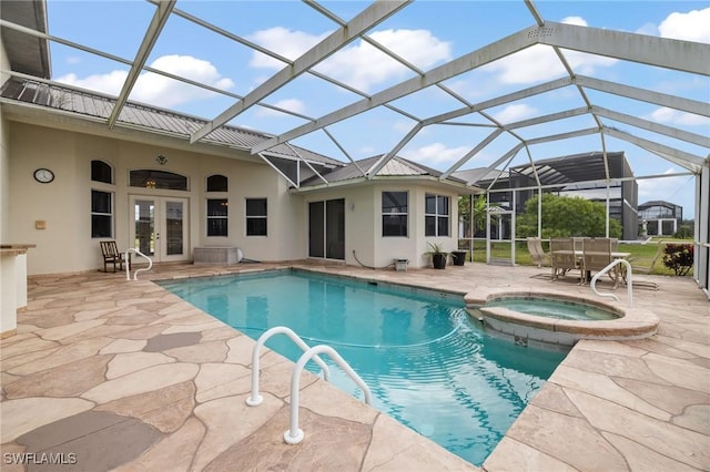 view of pool with french doors, a patio area, glass enclosure, and an in ground hot tub