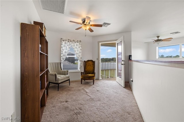 unfurnished room with ceiling fan and carpet