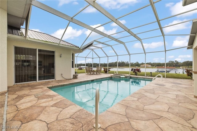 view of pool featuring a water view, a patio area, glass enclosure, and an in ground hot tub