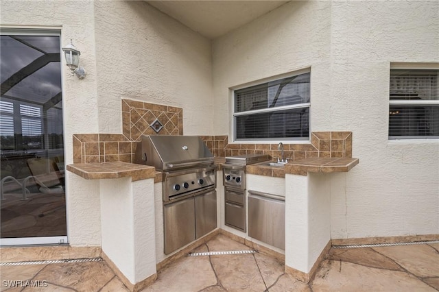 view of patio / terrace featuring sink, a grill, and area for grilling