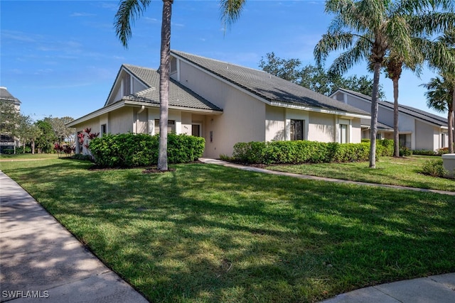 view of home's exterior with a lawn