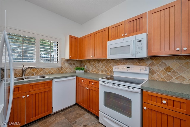 kitchen with sink, white appliances, and tasteful backsplash