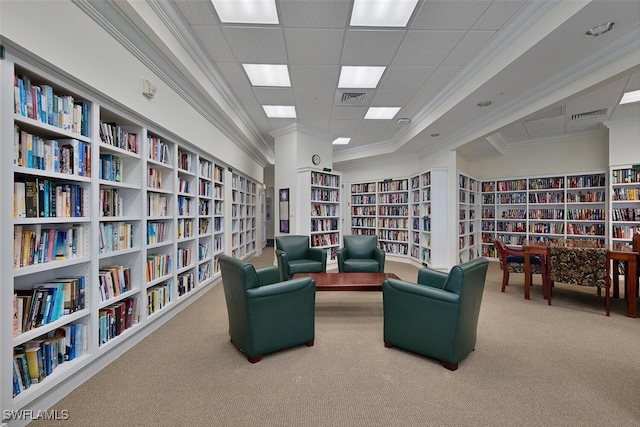 living area with carpet, ornamental molding, and built in shelves