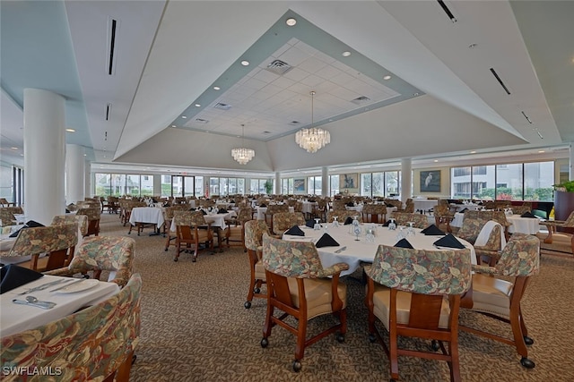 carpeted dining room with a high ceiling and a notable chandelier