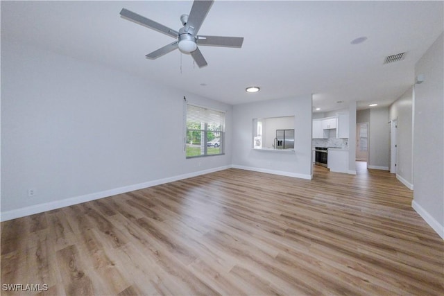 unfurnished living room with light hardwood / wood-style floors and ceiling fan