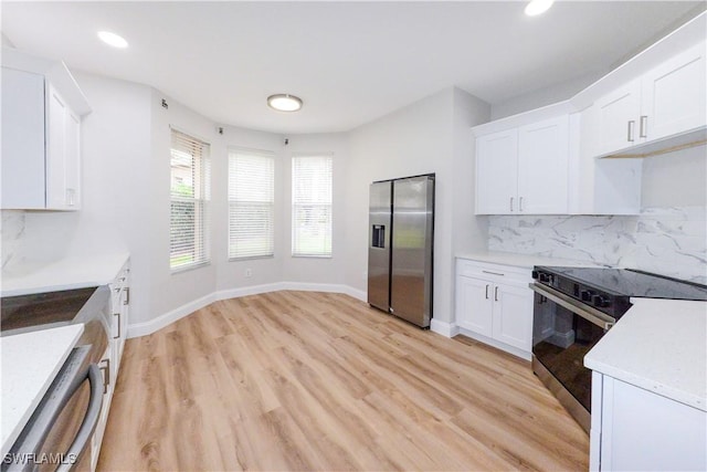 kitchen featuring white cabinetry, electric range, stainless steel fridge with ice dispenser, and tasteful backsplash