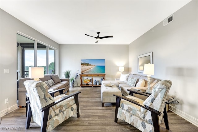 living room featuring ceiling fan and hardwood / wood-style floors