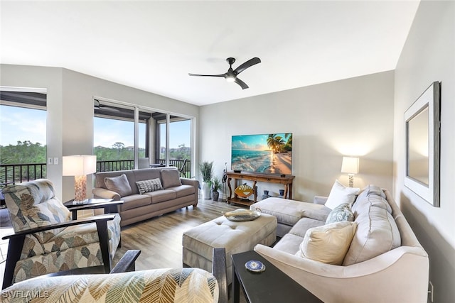 living room with ceiling fan and light hardwood / wood-style flooring