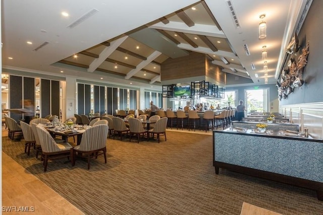 dining area with hardwood / wood-style flooring, high vaulted ceiling, and beamed ceiling