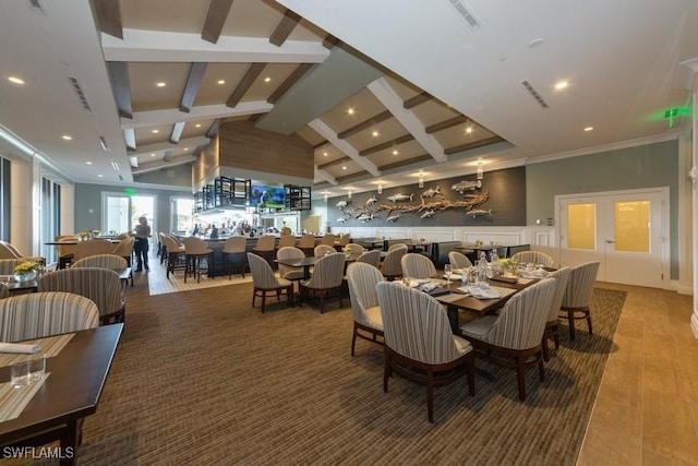 dining room with lofted ceiling with beams and wood-type flooring