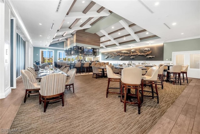 dining area with high vaulted ceiling and wood-type flooring