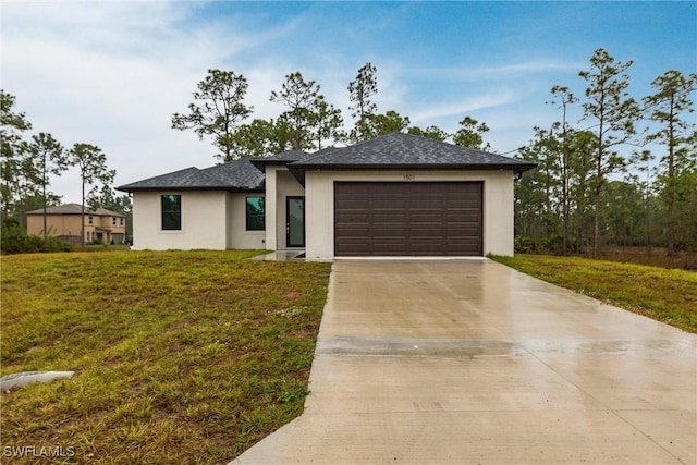 view of front facade with a garage and a front lawn