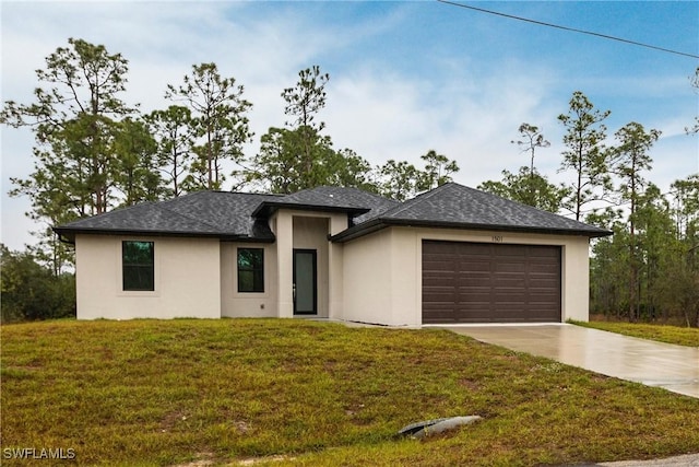 view of front of home featuring a garage and a front lawn