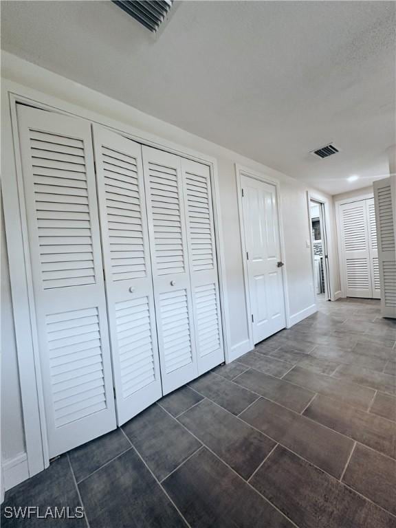 unfurnished bedroom with visible vents and baseboards