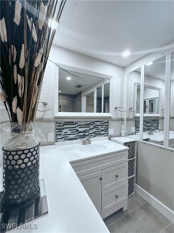 bathroom with vanity, backsplash, and tile patterned floors