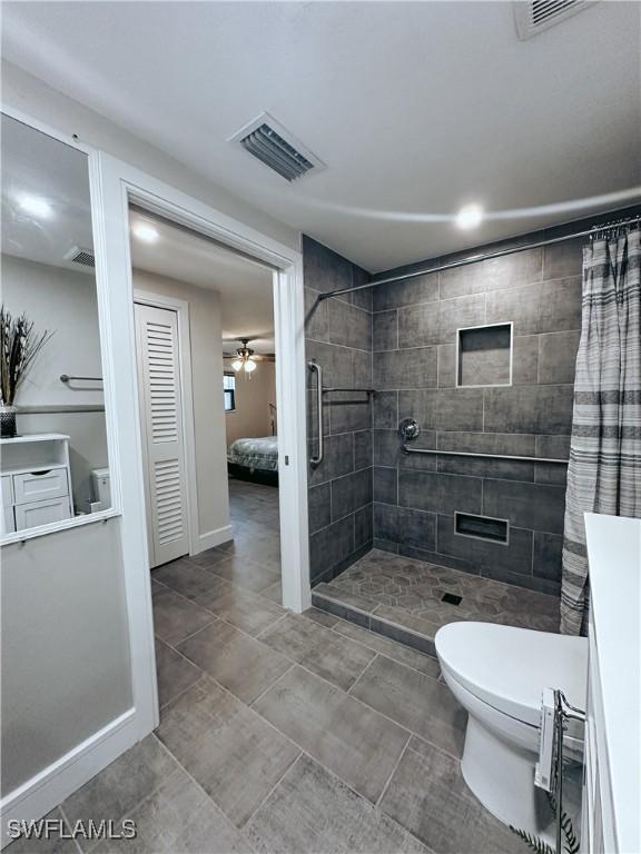 bathroom with toilet and walk in shower