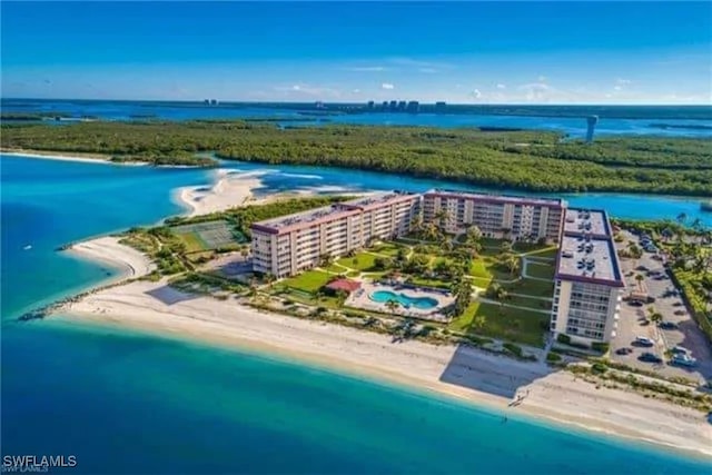 drone / aerial view featuring a water view and a view of the beach