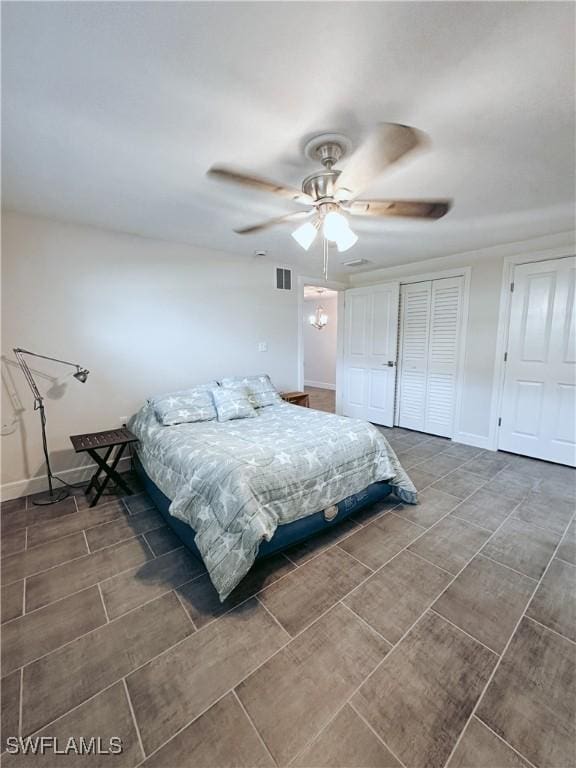 bedroom featuring a ceiling fan, visible vents, and baseboards