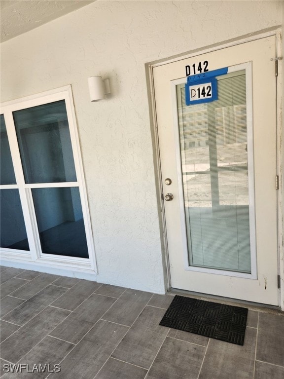 entrance to property with stucco siding