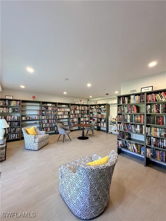 25740 Hickory Blvd Unit 142, Bonita Springs, FL 34134 - living area with bookshelves and recessed lighting