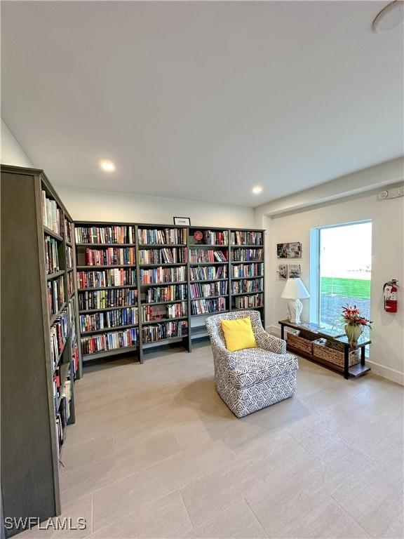 25740 Hickory Blvd Unit 142, Bonita Springs, FL 34134 - living area featuring wall of books