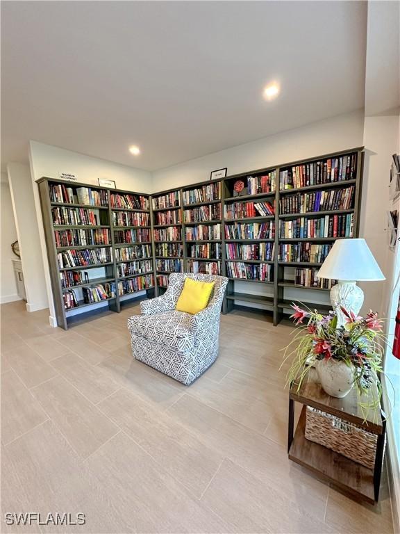 25740 Hickory Blvd Unit 142, Bonita Springs, FL 34134 - sitting room with wall of books