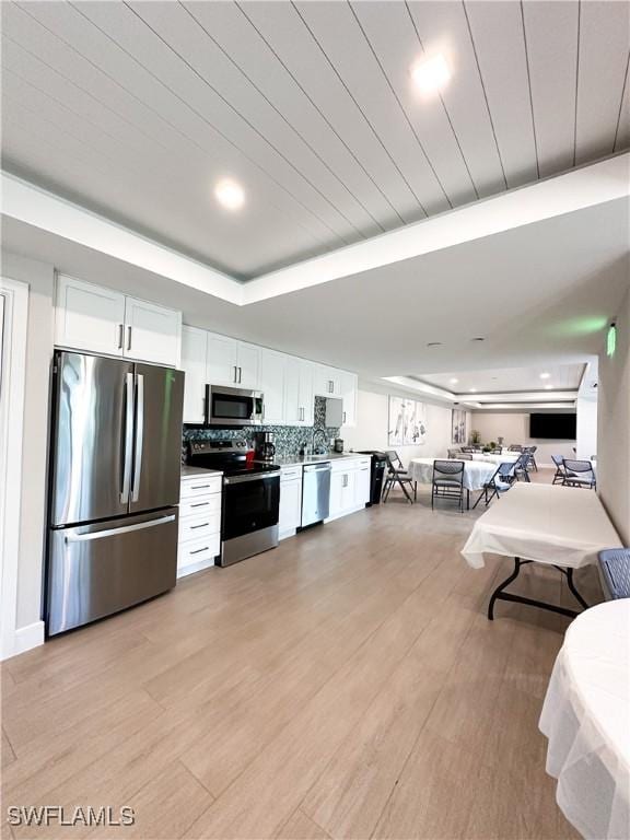 25740 Hickory Blvd Unit 142, Bonita Springs, FL 34134 - kitchen with stainless steel appliances, white cabinetry, and light wood-style flooring