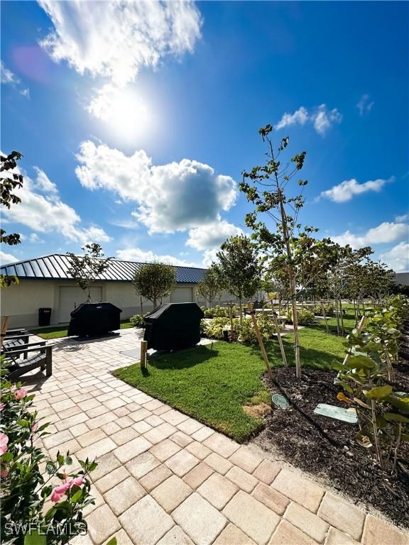 25740 Hickory Blvd Unit 142, Bonita Springs, FL 34134 - view of patio / terrace featuring an attached garage