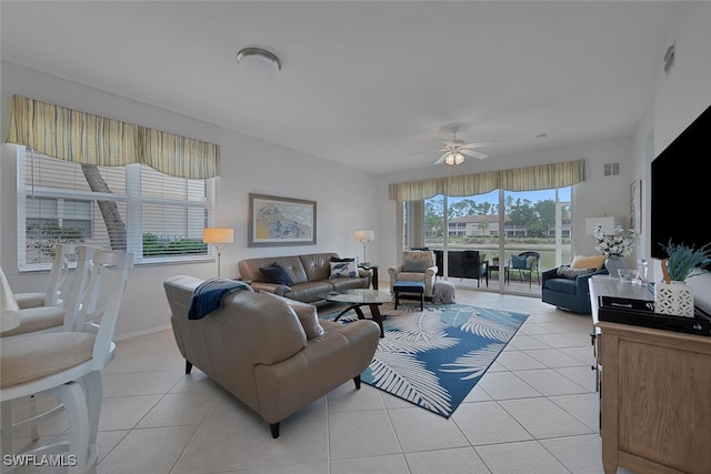 tiled living room with ceiling fan