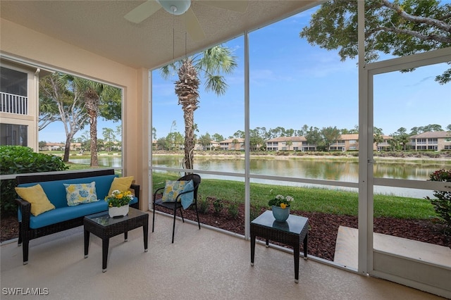 sunroom with a water view, ceiling fan, and plenty of natural light