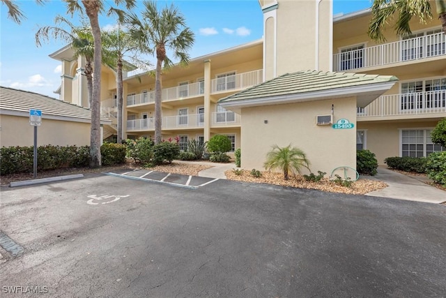 15495 Cedarwood Ln Unit 103, Naples, FL 34110 - view of apartment building / complex with uncovered parking