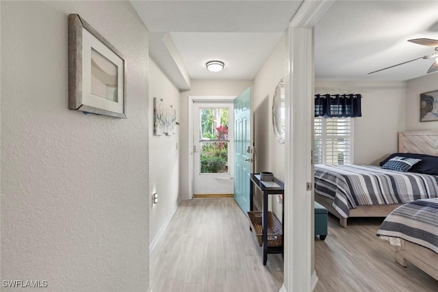 interior space with ceiling fan and light wood-type flooring