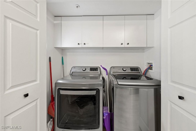15495 Cedarwood Ln Unit 103, Naples, FL 34110 - laundry area with cabinet space and washer and dryer