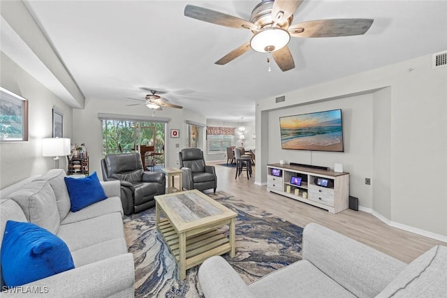 living room featuring ceiling fan and light hardwood / wood-style floors