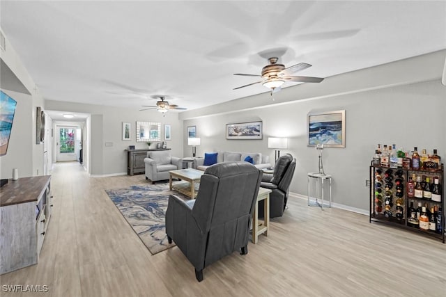 living room featuring light hardwood / wood-style floors and ceiling fan