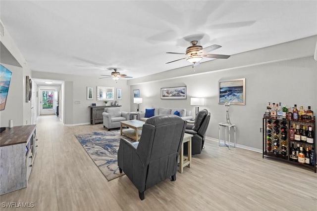 15495 Cedarwood Ln Unit 103, Naples, FL 34110 - living area with ceiling fan, light wood-type flooring, and baseboards